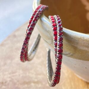Red rhinestone open hoop earrings with posts.